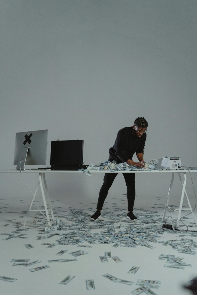 Businessman counting large sum of money on a desk, conveying themes of wealth and finance.