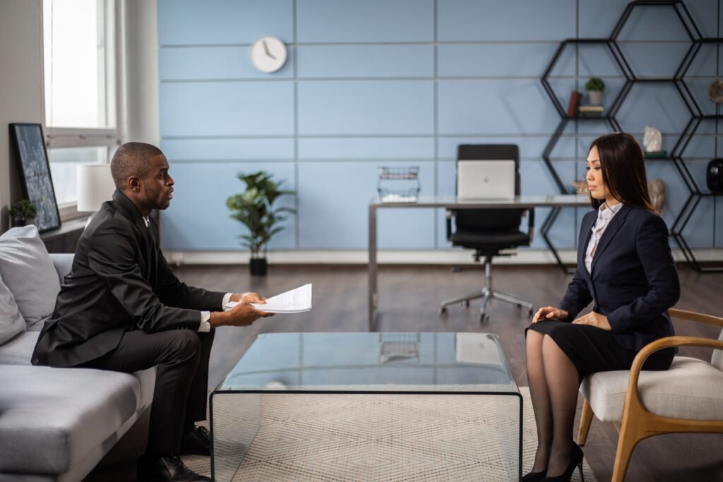 Business professionals having a meeting in a modern office setting, showcasing diversity and collaboration.